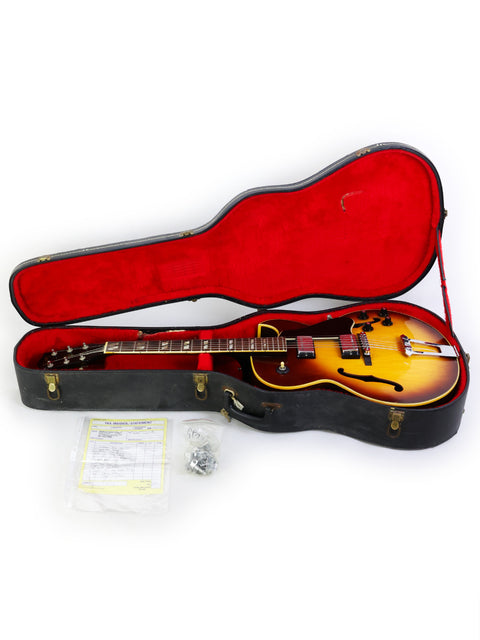 A 1970s Gibson ES-175D guitar resting in a bold red case, emphasizing its vintage charm and iconic design.