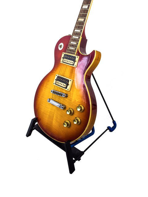 A 1977-78 Ibanez 'Lawsuit' Les Paul Custom Copy guitar resting on a stand, emphasizing its iconic style and Japanese heritage.
