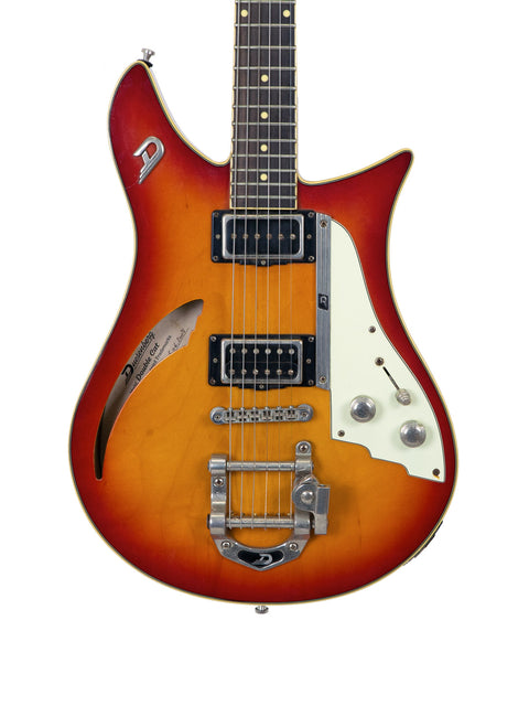 A Duesenberg Double Cat guitar with a sunburst finish, set against a clean white background, showcasing its elegant design.
