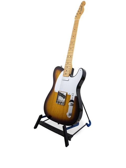 A Fender American Vintage ’58 Telecaster guitar displayed on a stand, set against a bright white backdrop, highlighting its features.
