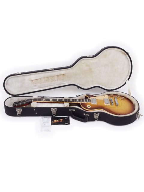 A Gibson Les Paul Traditional guitar from 2009, securely placed in its case, showcasing its elegant design and craftsmanship.