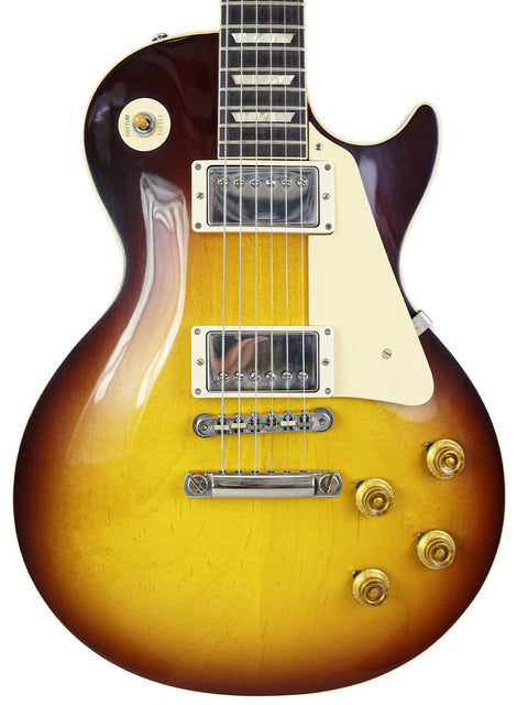 A Gibson guitar with a sunburst finish, showcasing the 60th Anniversary 1960 Les Paul Standard R/I from the Custom Shop.