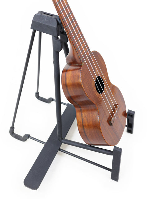 A Hawaiian Paul F. Summers 'Moana' Style 5 Koa Ukulele from 1927, positioned on a stand, highlighting its unique design.
