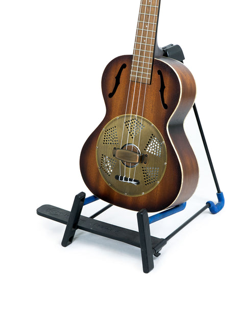 A Kala KA-RES-BRS Tenor Resonator Ukulele from 2019 is positioned on a stand, ready for play.
