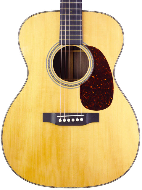  A Martin Custom Shop 000-28 acoustic guitar from 2018, showcasing its elegant design and rich wood finish.
