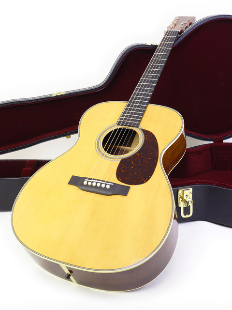 A Martin Custom Shop 000-28 guitar nestled in its protective case, highlighting its exquisite build from the USA in 2018.