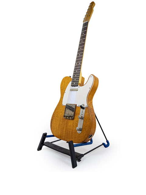 A Silky Oak Txxx Style Partscaster guitar on a stand against a clean white background, showcasing its new design from 2021.
