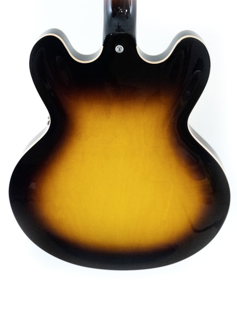 A beautiful sunburst guitar, the Gibson Custom ES-335 from 2012, adorned with classic dot inlays, exemplifying fine artistry.