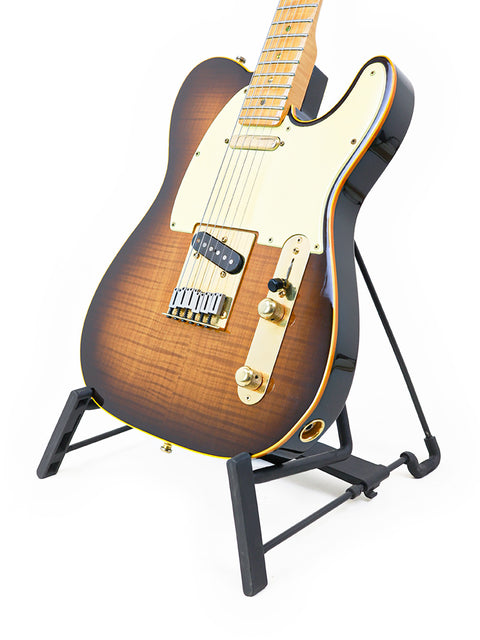 A black-bodied Fender Telecaster guitar on a stand, celebrating its 40th Anniversary with a limited edition tag from 1988.