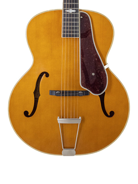 A brown Epiphone Masterbilt De Luxe F-Hole Archtop guitar with a sleek black pick guard, showcasing its elegant design.
