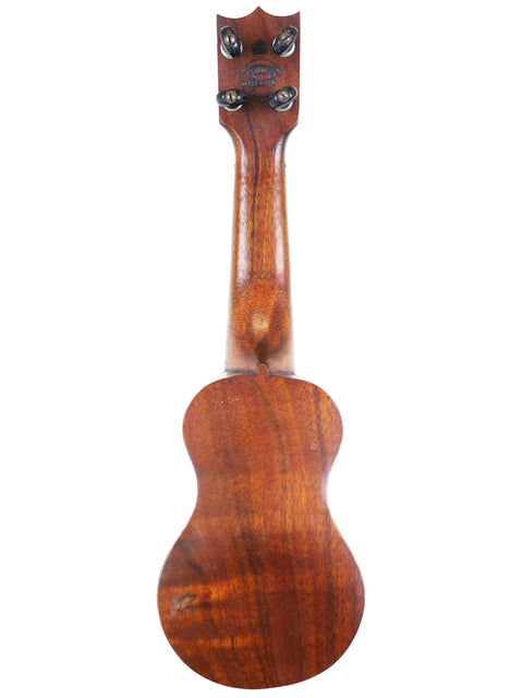 A charming TABU Style 2 "Midget" Koa Ukulele from Hawaii, showcasing its lovely wooden body and neck from c.1917.