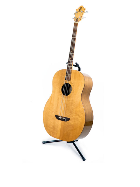 A classic 1980s Ernie Ball Earthwood Bass guitar resting on a stand, set against a bright white background.