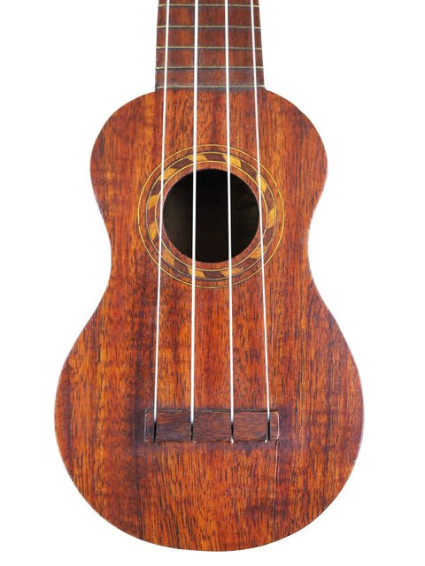 A classic Hawaiian TABU Style 2 "Midget" Koa Ukulele with a stunning wooden body and neck, dating back to 1917.