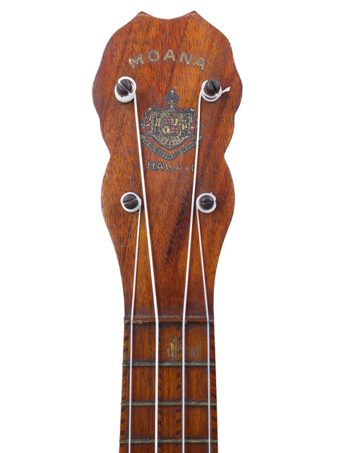 A classic Hawaiian ukulele from 1927, showcasing a wooden body and headstock, crafted by Paul F. Summers.

