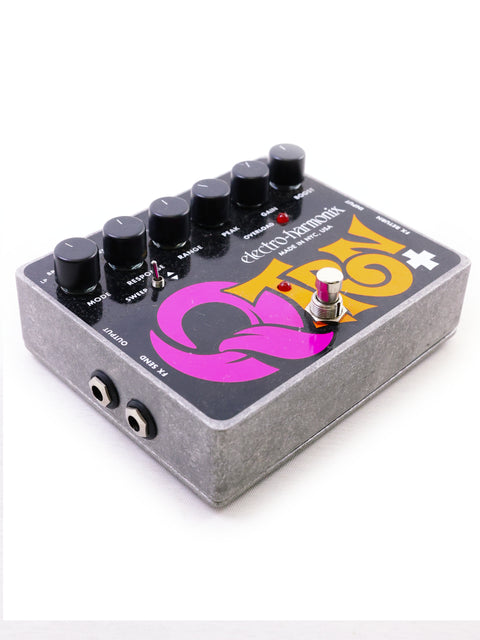 A guitar effects pedal with knobs and switches on a white background.