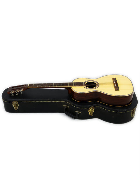 A guitar resting in its case against a white background, captured in Gilet Bay State, Australia, in 2018.