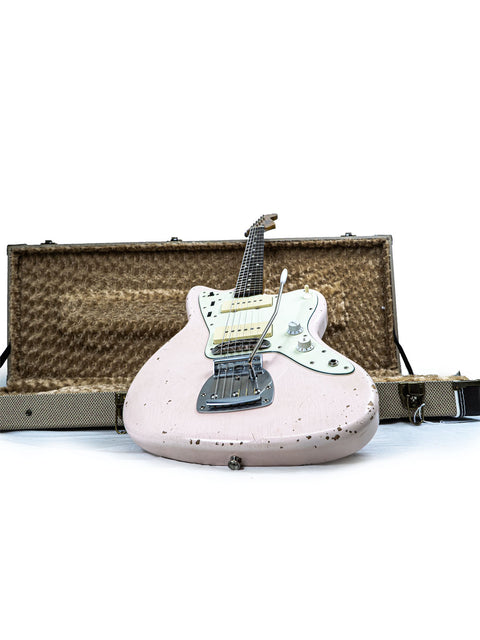 A pink Rittenhouse JM-63 guitar in its case, displayed on a white background. Made in the USA, 2020 edition.