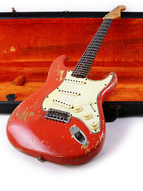 A red 1964 Fender L Series Stratocaster guitar in a case, displayed on a clean white background.