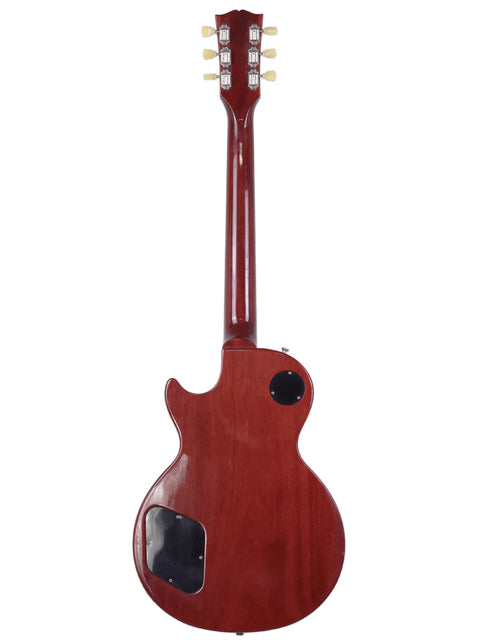 A red Gibson Les Paul Traditional electric guitar set against a clean white background, showcasing its sleek design.