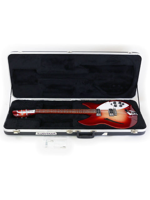 A red Rickenbacker 330 electric guitar in its case, displayed on a white background.