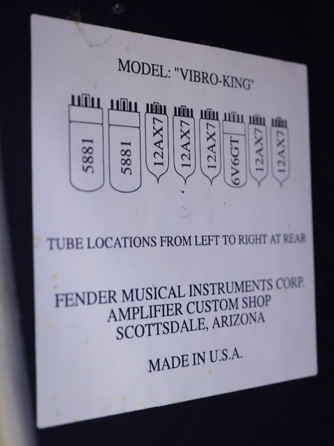 A sign on a black wall proclaims "Model Vibro - King," showcasing the 2003 Fender Custom Shop amplifier.