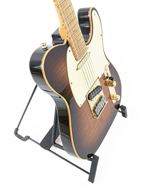 A striking black guitar with a brown neck displayed on a stand, representing the limited edition Fender Telecaster from 1988.