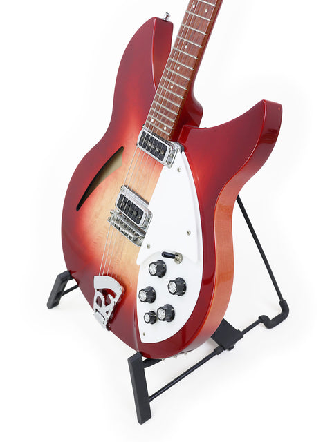 A striking red Rickenbacker 330 guitar on a stand, featuring a white background, highlighting its 2006 Fireglo design.
