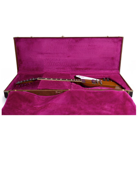 A stylish mahogany case for a Gibson Firebird V Reissue from 1991, emphasizing its rich color and protective features.