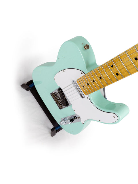 A vibrant green electric guitar against a white backdrop, featuring the 2018 Fender Custom Shop 60s Journeyman Telecaster.

