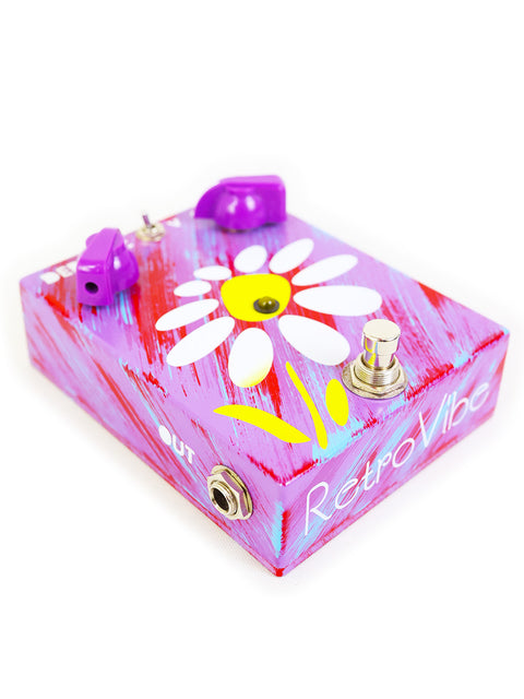 A vibrant purple pedal box adorned with a flower motif, identified as JAM Pedals RetroVibe mk.2 from Greece.
