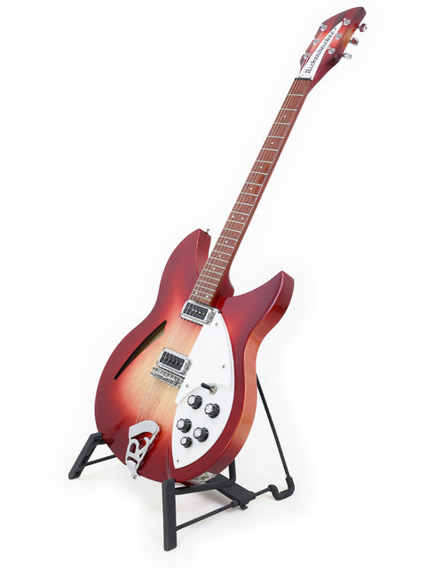 A vibrant red Rickenbacker 330 guitar on a stand, set against a white background.