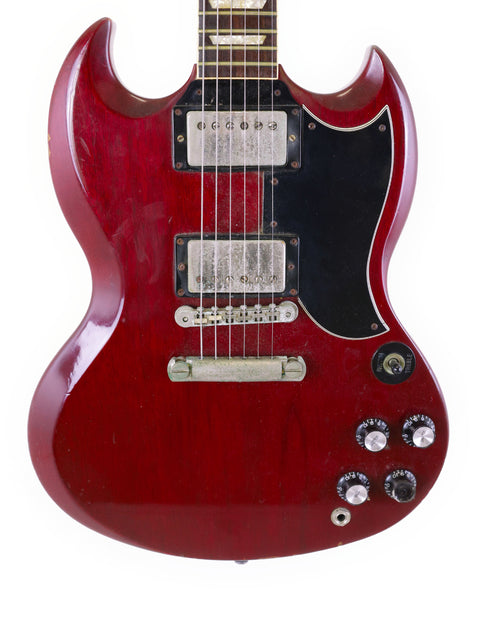 A vibrant red electric guitar, the Gibson SG '61 Reissue from 1988, equipped with a sleek black pickup for a striking look.