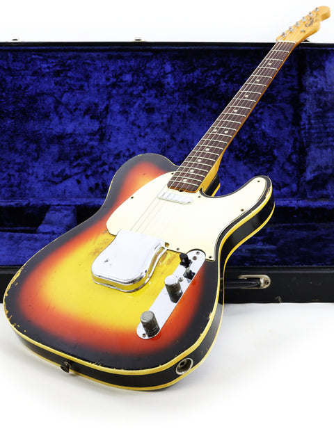 A vintage 1966 Fender Custom Telecaster guitar nestled in its case, highlighting its iconic shape and rich history.