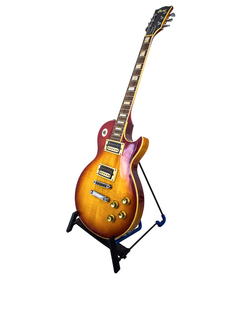 A vintage 1977-78 Ibanez 'Lawsuit' Les Paul Custom Copy guitar resting on a stand, set against a clean white background.