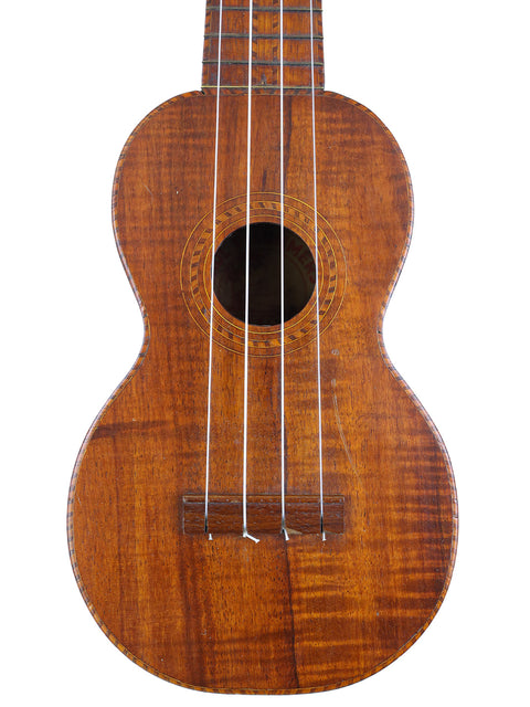 A vintage Paul F. Summers 'Moana' Style 5 Koa Ukulele from Hawaii, featuring a beautiful wooden body and neck.