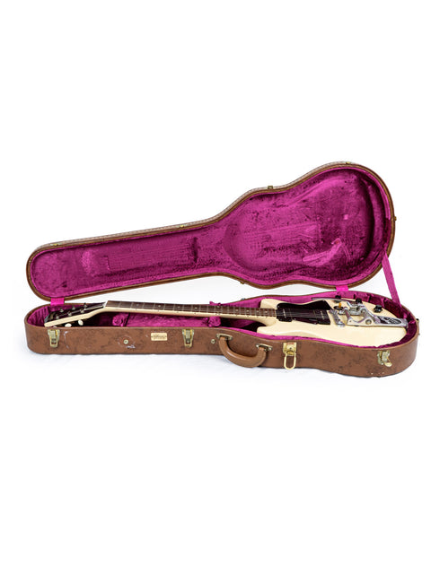 A white 1959 Gibson Les Paul Special Refin guitar nestled in a case featuring a vibrant pink lining.