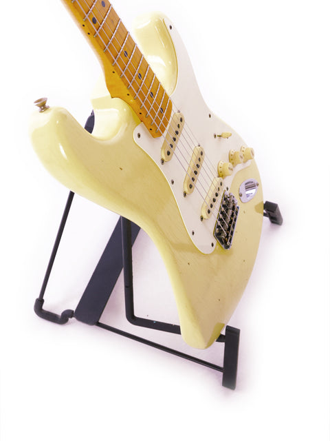  A white Fender Ltd Custom 50s Journeyman Stratocaster guitar displayed on a black stand.
