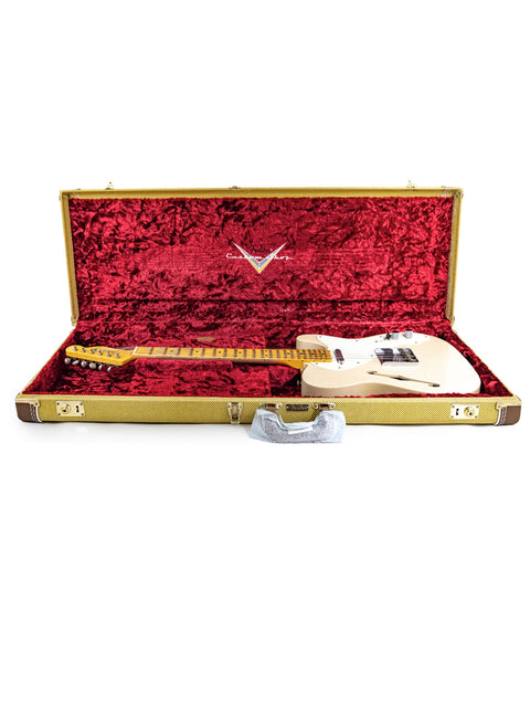 A white guitar, the Fender Custom Shop '50s Thinline Relic Telecaster, resting in its case on a pristine white backdrop.
