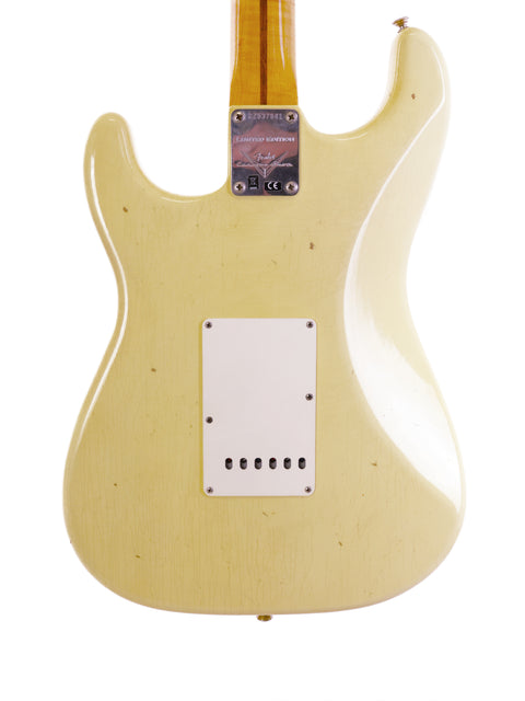 A white guitar with a wooden body and white pickguard, specifically the Fender Ltd Custom 50s Journeyman Stratocaster.