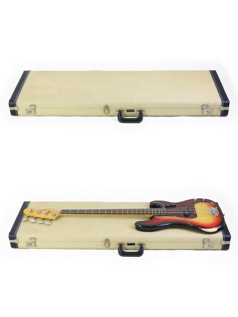 A wooden case containing two bass guitars, featuring a vintage 1972 Fender Precision Bass with a '63 neck.
