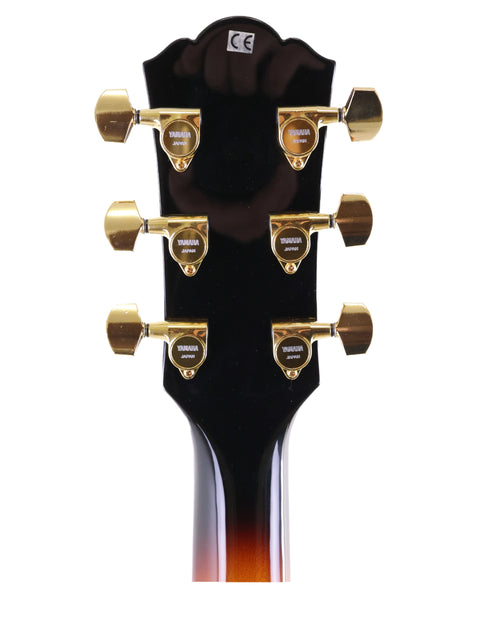 Aesthetic close-up of the Yamaha AEX1500 headstock, featuring exquisite gold hardware, made in Japan in 2004.
