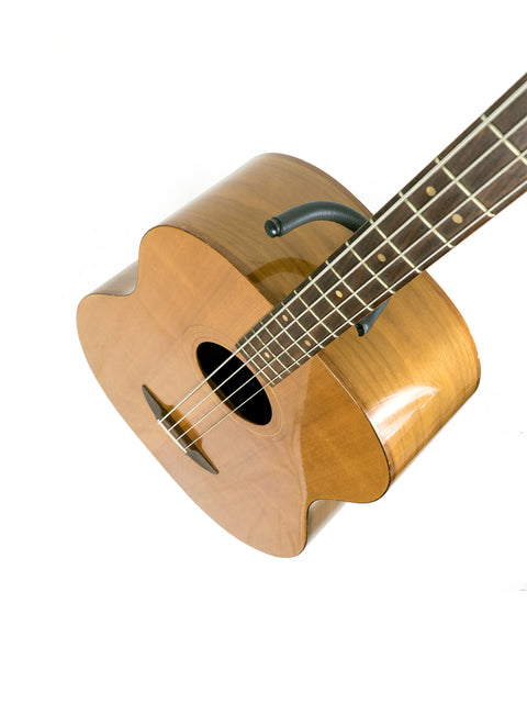 An 80s Ernie Ball Earthwood Bass guitar prominently featured on a white background.