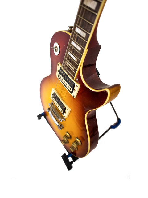 An Ibanez 'Lawsuit' Les Paul Custom Copy guitar from 1977-78 displayed on a stand with a white backdrop.