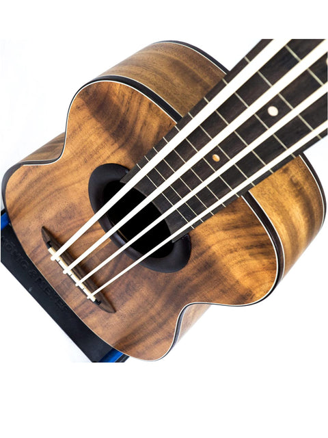 Angled view of aNueNue Im Bass Koa Bass Ukulele highlighting strings and fretboard.