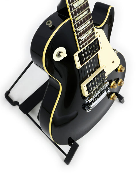 Black electric guitar on a stand, featuring the Tokai Les Paul Reborn LS50 model from Japan, 1979.