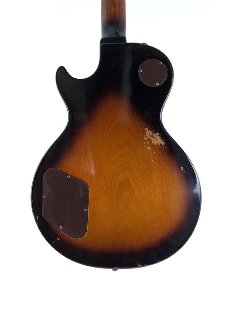 Brown-bodied 1973 Gibson Les Paul Standard guitar, complemented by a stylish black pickguard.