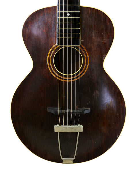 Classic 1930s Gibson J-45 acoustic guitar, representing vintage American craftsmanship and musical history.
