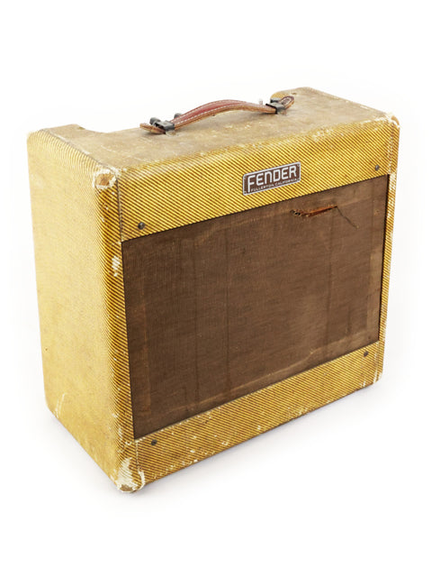 Classic 1955 Fender Tweed Deluxe Amp 5D3 in yellow, showcased on a pristine white backdrop for a striking visual appeal.