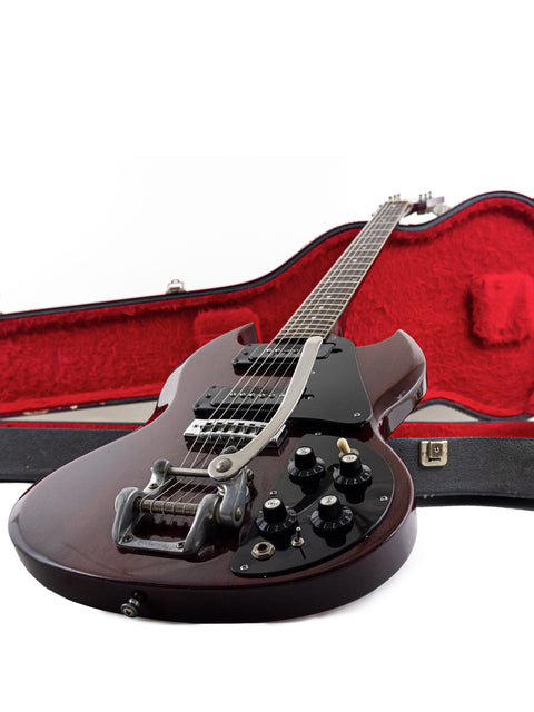 Classic 1972 Gibson SG Pro guitar in black, elegantly placed in a vibrant red case, perfect for vintage enthusiasts.