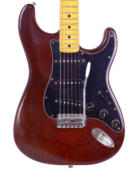 Classic brown electric guitar, a 1979 Fender Stratocaster, with a vibrant yellow pickup, perfect for music enthusiasts.